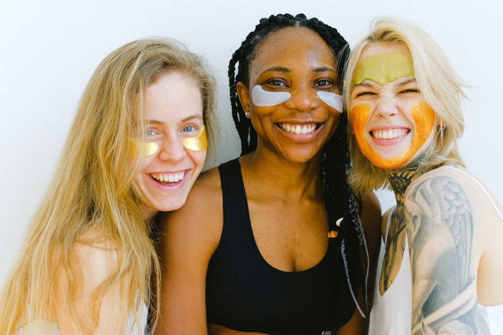 pexels-photo-3851696 Group of women with masks and patches smiling while looking at camera and laughing during skincare procedure in studio on weekend