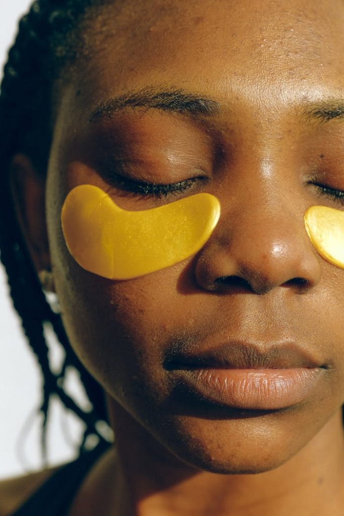 pexels-photo-3852204 Crop gentle African American female with closed eyes and clean face enjoying cosmetic procedure for smoothing and moisturizing skin under eyes and removing dark circles