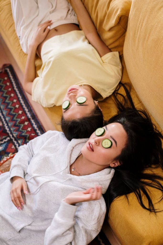 pexels-photo-4004122 Two women enjoying a relaxing spa day with cucumber masks in a cozy home setting.